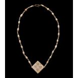 A Western Asiatic Stone and Shell Bead Necklace Length 11 1/4 inches (29 cm).