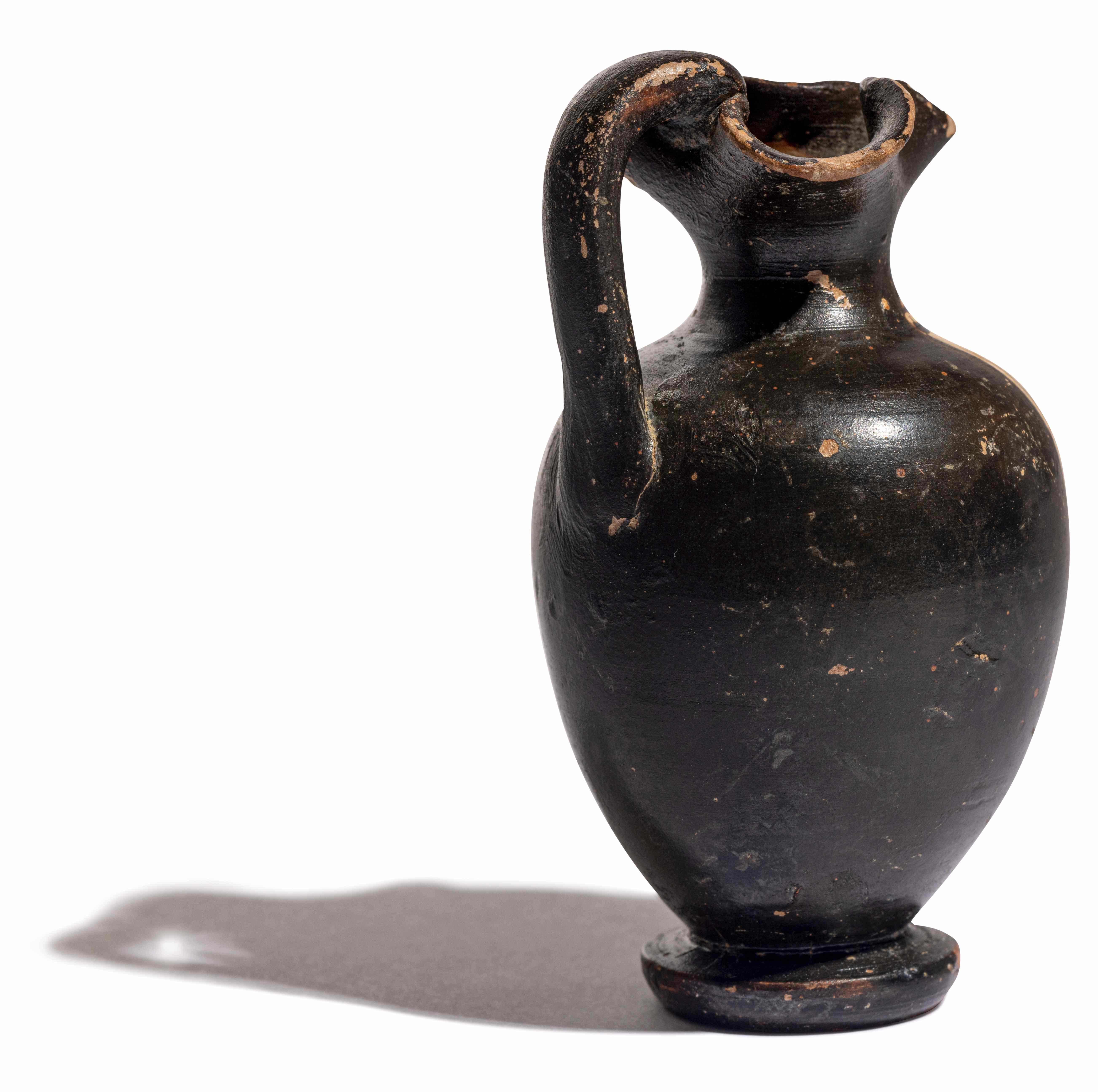 A Greek Black-Figured Trefoil Oinochoe Height 3 3/4 inches (10 cm). - Image 7 of 12