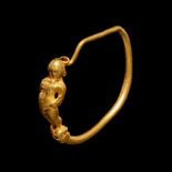 A Hellenistic Gold Earring with Eros Playing the Flute Diameter 1 1/8 inches (3 cm).