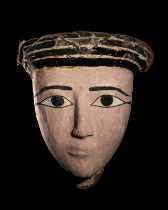 An Egyptian Wood and Painted Cartonnage Mummy Mask  Height 13 3/4 inches (34.9 cm).