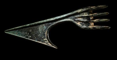 A Luristan Bronze Axehead Length 9 1/8 inches (23.2 cm).