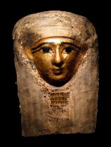 An Egyptian Cartonnage Mummy Mask Height 14 3/16 inches (36.1 cm).
