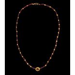 A Roman Gold and Garnet Bead Necklace  Length 11 1/8 inches (28.3 cm).