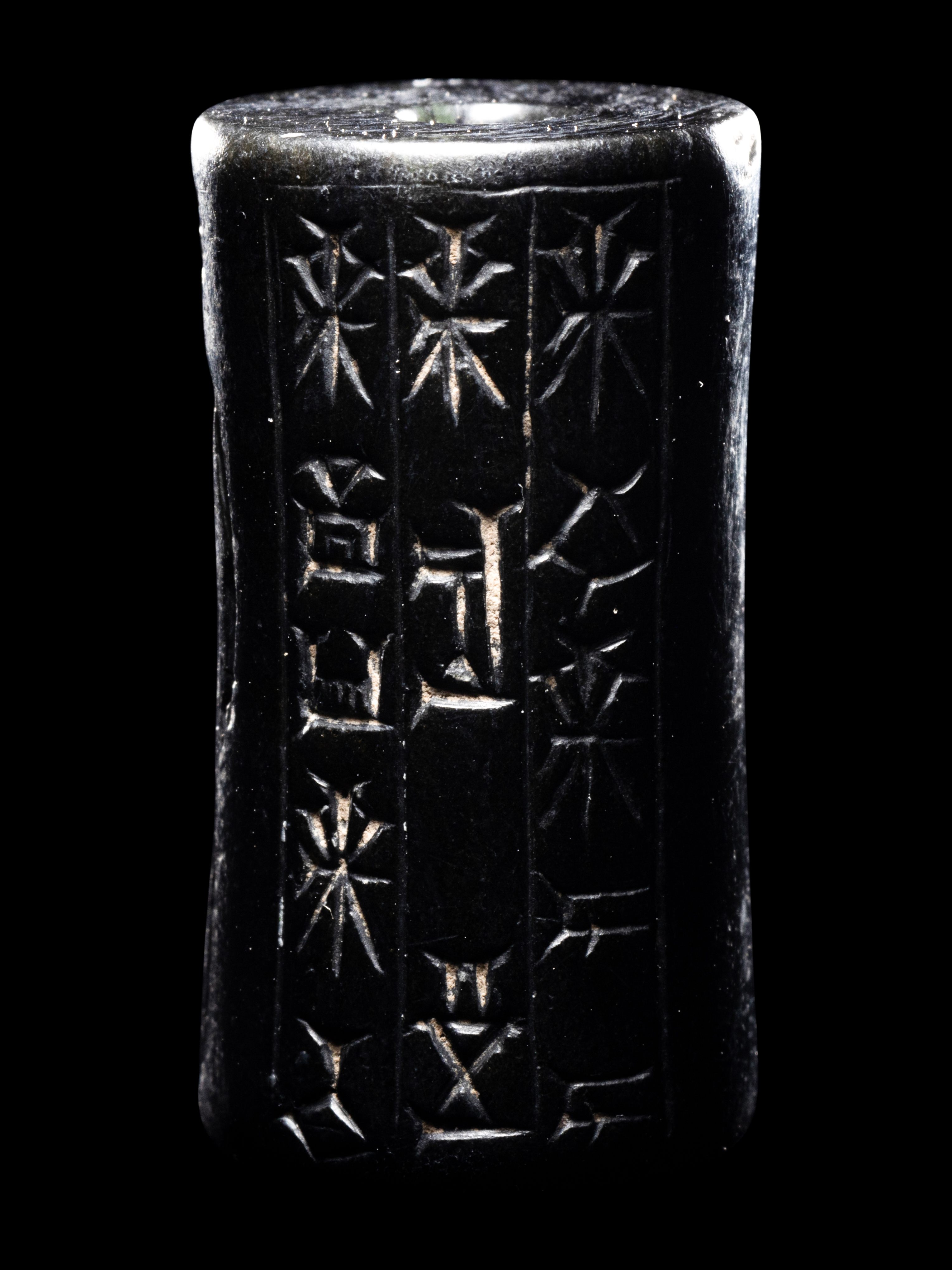 A Mesopotamian Hematite Cylinder Seal Height 1 1/16 inches (2.7 cm).