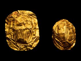 Two Egyptian Gold Scarabs  Height of largest 1 5/16 inch (3.5 cm).