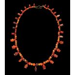 An Egyptian Carnelian and Red Jasper Bead Necklace  Length 10 3/8 inches (26.4 cm).