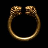 A Western Asiatic Gold Bracelet with Lion-Headed Terminals Diameter 4 3/4 inches (12.1 cm).