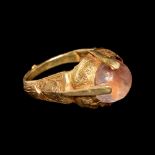 An Islamic Gold Finger Ring with Rock Crystal Cabochon Ring size 3 3/4; Diameter of rock crystal 3/4