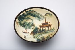 A BLACK GLAZED AND LANDSCAPE PAINTED BOWL