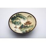 A BLACK GLAZED AND LANDSCAPE PAINTED BOWL