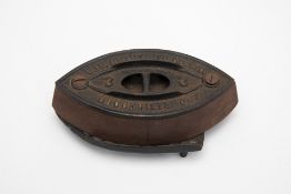 AN ANTIQUE AMERICAN CAST IRON IRON AND TRIVET