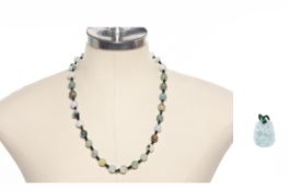 A JADE BEAD NECKLACE AND A DRAGON MOTIF PENDANT