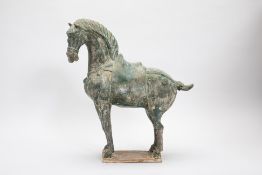 A TANG STYLE GREEN GLAZED MODEL OF A HORSE