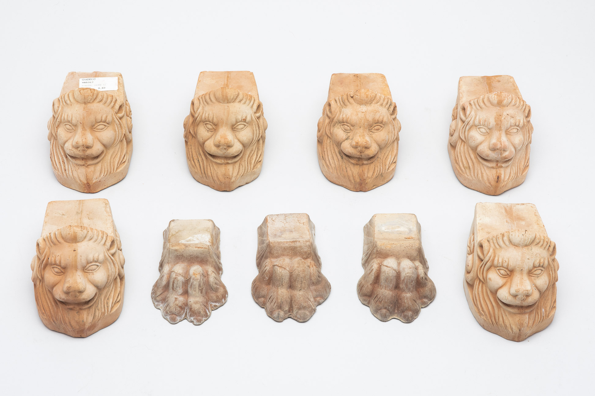 A GROUP OF ITALIAN TERRACOTTA LION HEAD AND FEET POT STANDS