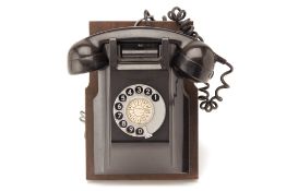 A WALL MOUNTED BAKELITE TELEPHONE