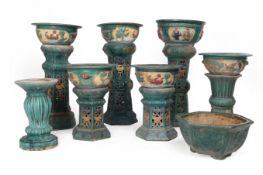 A GROUP OF SEVEN CERAMIC GARDEN POTS ON PLINTHS