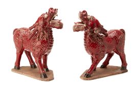 A PAIR OF ORIENTAL RED GLAZED MODELS OF QILINS