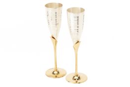 A PAIR OF PARCEL GILT SILVER CHAMPAGNE FLUTES