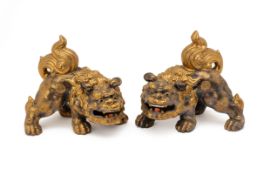 A PAIR OF ORIENTAL PORCELAIN MYTHICAL BEASTS