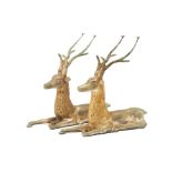 A PAIR OF METALWARE MODELS OF RECLINING STAGS