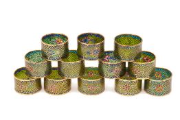 A SET OF TWELVE PLIQUE-À-JOUR ENAMEL NAPKIN RINGS