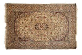 A PERSIAN MEDALLION WOOL CARPET