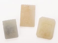 A GROUP OF THREE RECTANGULAR CARVED JADE PENDANTS