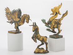 A GROUP OF THREE GILT COPPER REPOUSSE FIGURES OF ANIMALS
