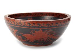A LARGE RED AND BLACK LACQUERED BOWL