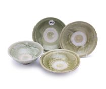 A GROUP OF FOUR VIETNAMESE GREEN GLAZED SHALLOW DISHES