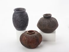 A GROUP OF THREE CARVED POTTERY VESSELS