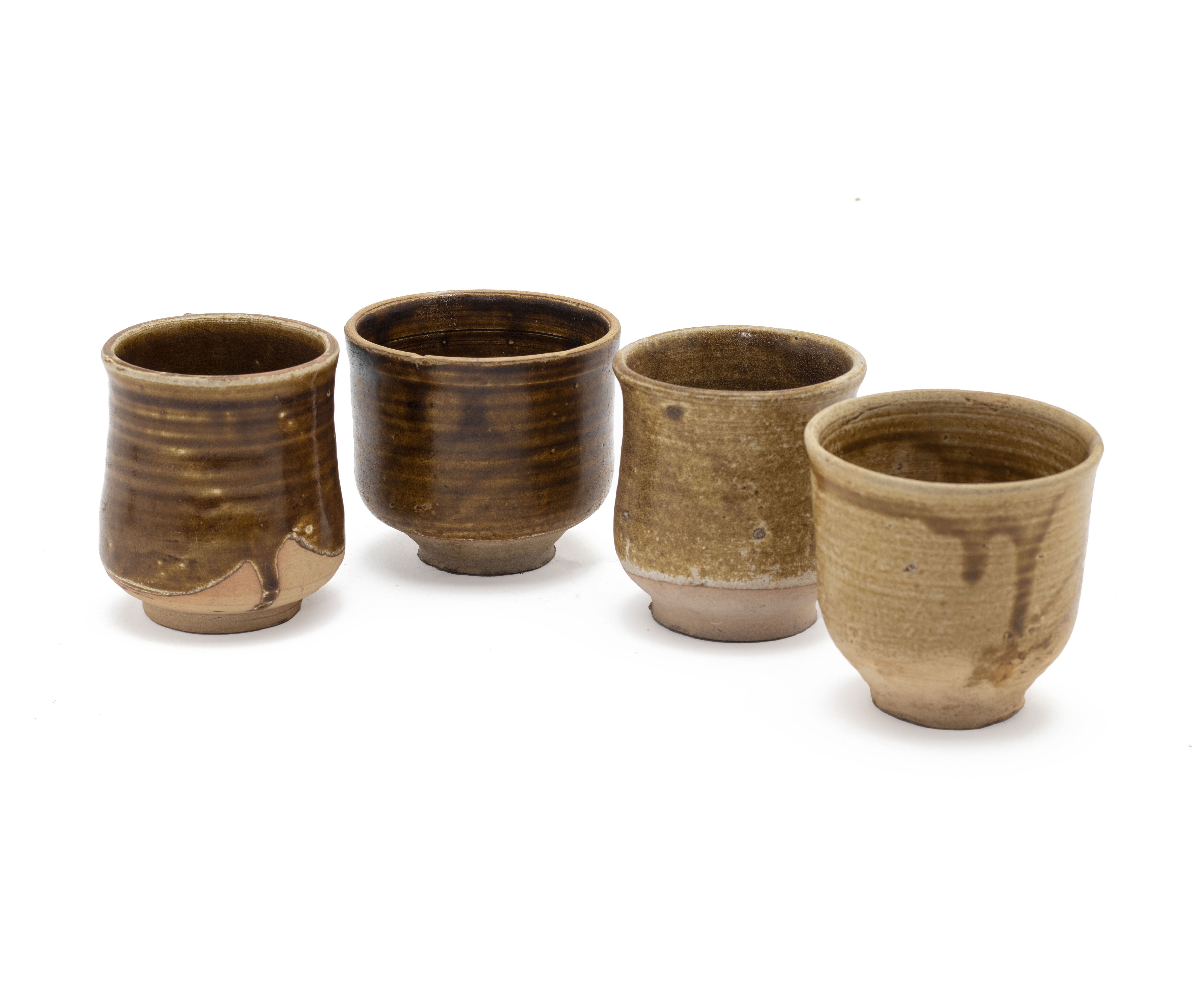 A GROUP OF FOUR POTTERY BEAKERS