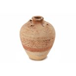 A CARVED EARTHENWARE JAR