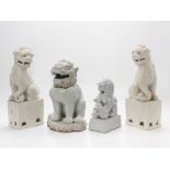 A GROUP OF FOUR WHITE GLAZED FOO DOGS