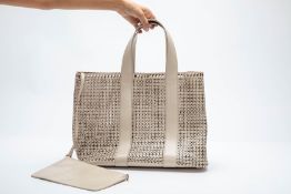 AN ALAÏA LASER CUT LEATHER EYELET TOTE BAG