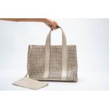 AN ALAÏA LASER CUT LEATHER EYELET TOTE BAG