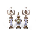 A FRENCH GILT METAL MOUNTED BLUE AND WHITE CLOCK GARNITURE