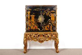 A BLACK JAPANNED CABINET ON GILTWOOD STAND