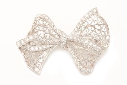 A BOW SHAPED DIAMOND BROOCH