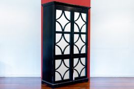 A MIRROR FRONTED BLACK CABINET