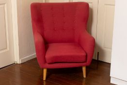 A LARGE UPHOLSTERED ARMCHAIR