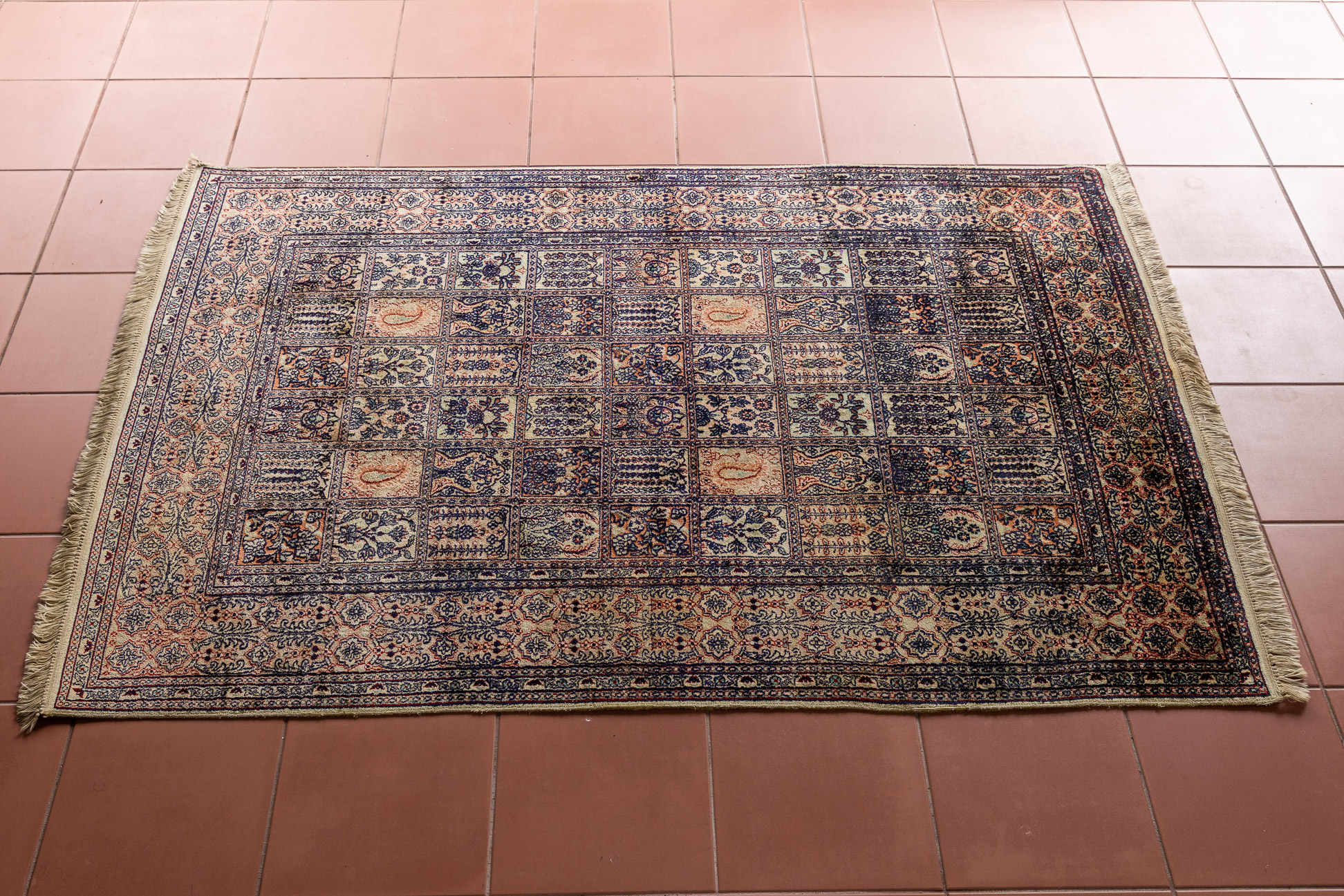 A PANELLED GARDEN DESIGN RUG