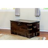 A COLONIAL BRASS BOUND HARDWOOD TRUNK
