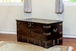 A COLONIAL BRASS BOUND HARDWOOD TRUNK