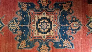 A RED GROUND MEDALLION WOOL RUG