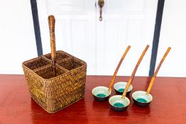 A WOVEN BASKET WITH FOUR CERAMIC WOVEN HANDLED SPOONS