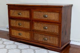 A WOOD AND RATTAN CHEST OF DRAWERS