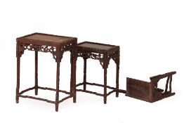 A SET OF THREE GRADUATED CHINESE CARVED HARDWOOD SIDE TABLES