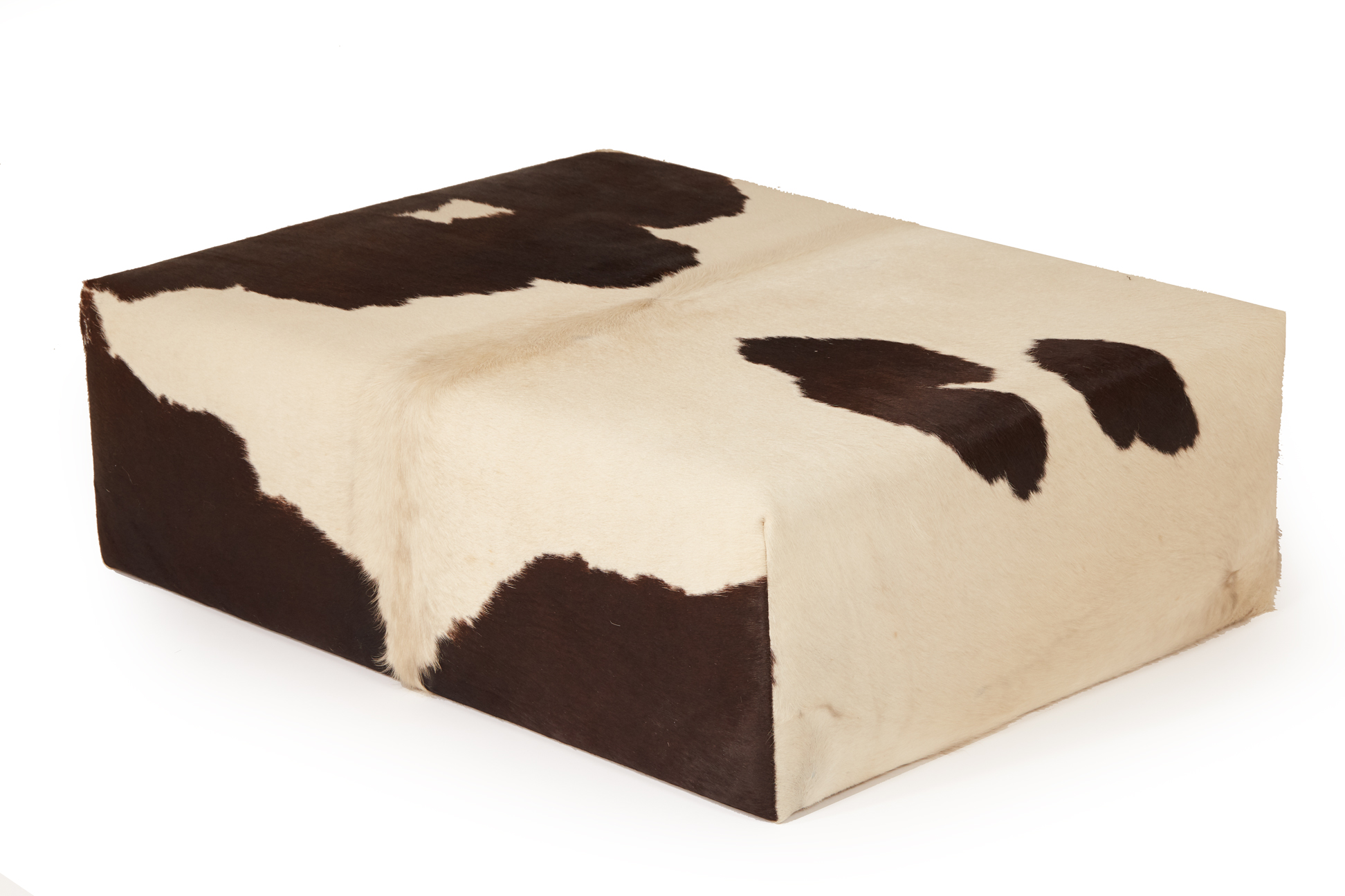 A COW HIDE OTTOMAN