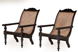 A PAIR OF EBONISED PLANTER STYLE ARMCHAIRS